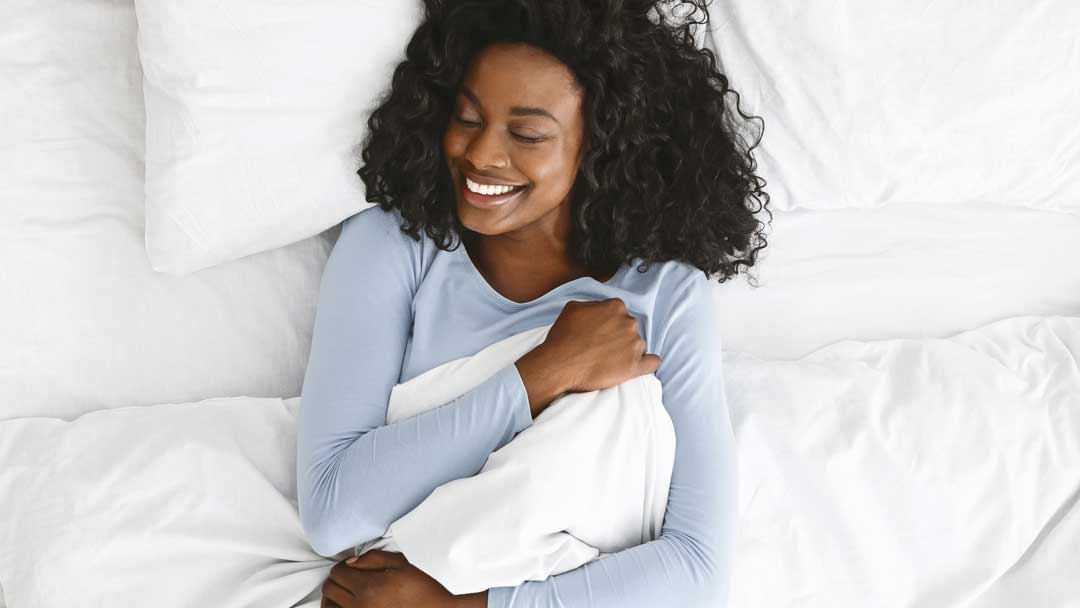 smiling woman waking up in her comfortable wall bed
